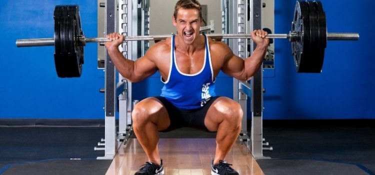 Muscle & Strength Athlete Barbell Squatting in Gym